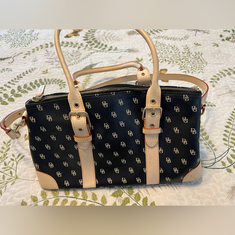 Genuine Dooney and Bourke black and tan crossbody purse.